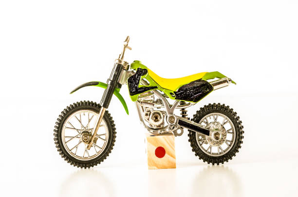 istock A toy motorcycle is sitting on a wooden block 2194043335