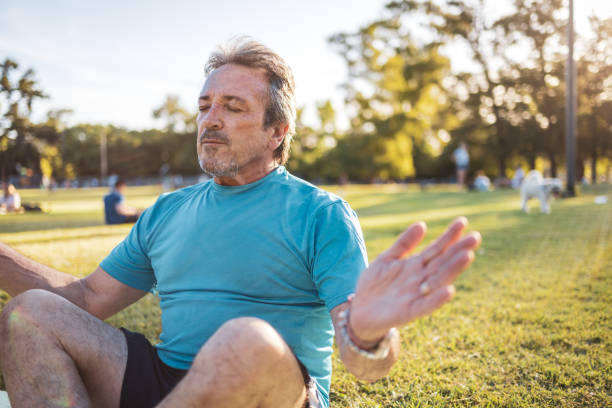istock Man meditating outdoors in a sunny park during a peaceful morning 2194045211