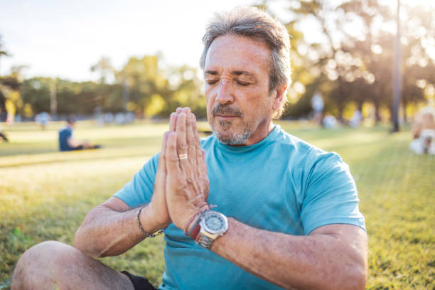 istock Senior man meditating in a park during a sunny afternoon 2194045221