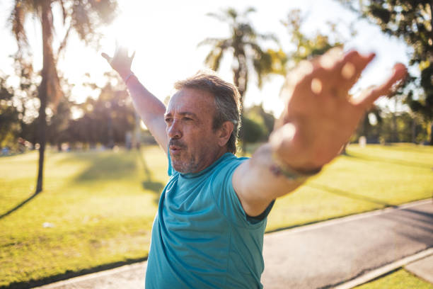 istock Man stretching arms in a park during a sunny day 2194045246