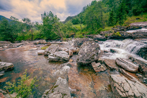 Beautiful mountain river. Cascade mountain stream with rapids and a waterfall