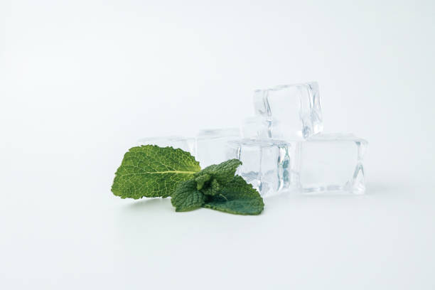 istock Fresh mint leaves and clear ice cubes on a white background. A minimalistic composition emphasizing freshness and simplicity, perfect for concepts related to beverages, cooling, or summer 2194047155