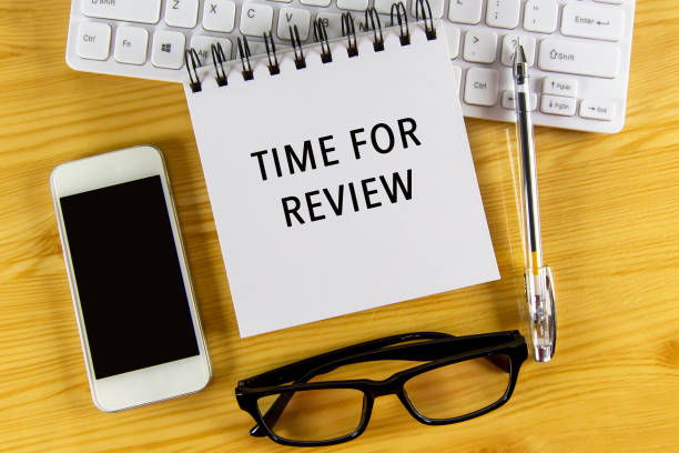 istock White notepad with text Time For Review lying on laptop on wooden table. 2194047928