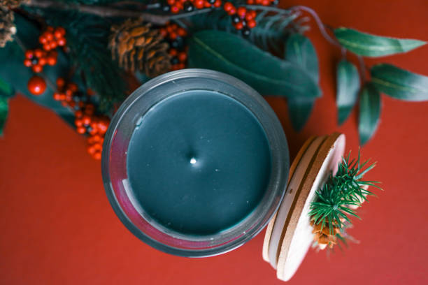 A festive glass candle labeled 