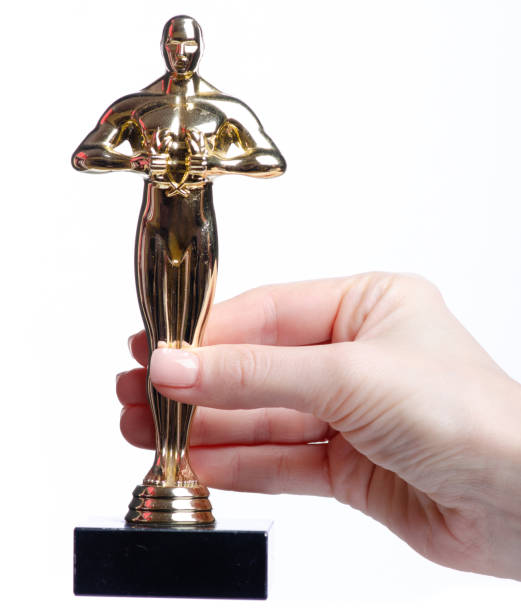 istock golden trophy man in hand 2194049667