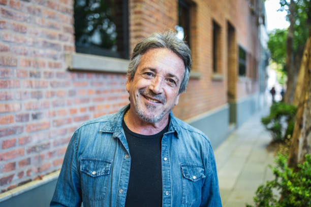 istock Happy senior man smiling outdoors in an urban environment. Looking at the camera 2194050019