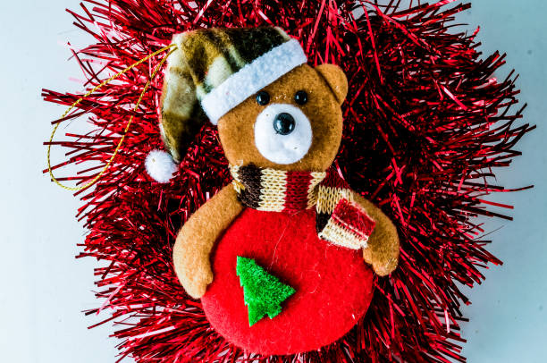 A woman in front of a fireplace with a Christmas decoration