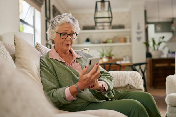 istock Senior woman using mobile phone at home 2194051872