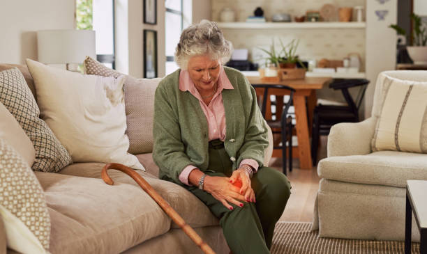 istock Old woman suffering knee pain while holding it 2194051937
