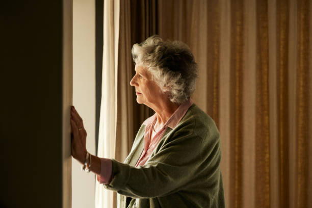 Pensive senior woman at home thinking