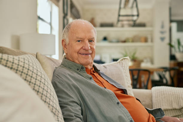 istock Portrait of elderly man relaxing on sofa 2194052050