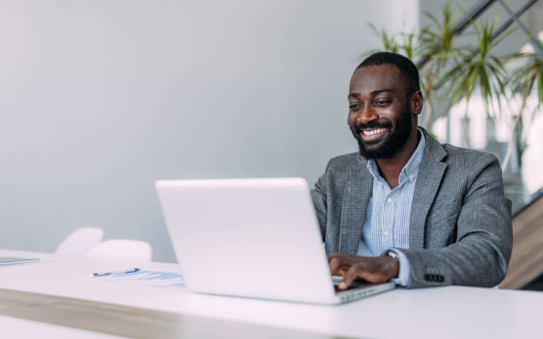 istock Successful businessman in modern office working on laptop. 2194052221