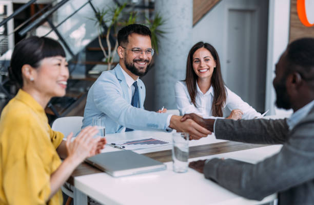 istock Businesspeople shaking hands across the table. 2194052315