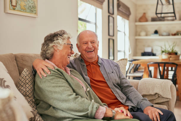 istock Happy retired couple laughing at home 2194052358