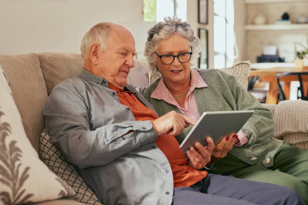 istock Old couple using digital tablet at home together 2194052369