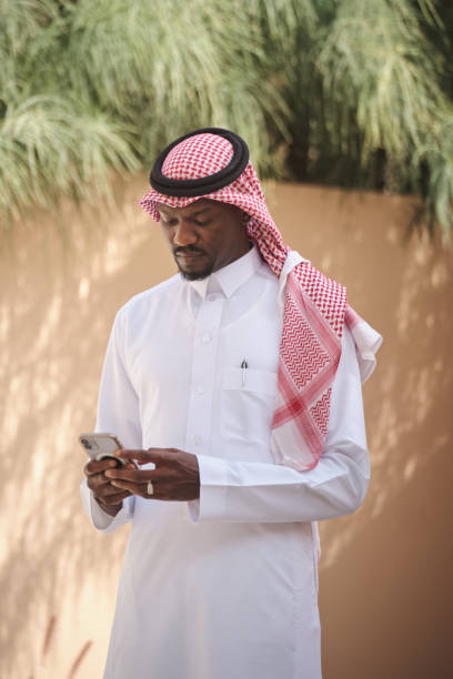 istock Smart Arab businessman wearing a traditional Saudi clothes using his mobile phone 2194052612