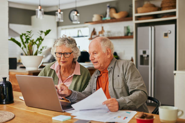 istock Focused elder couple managing home finances 2194052708