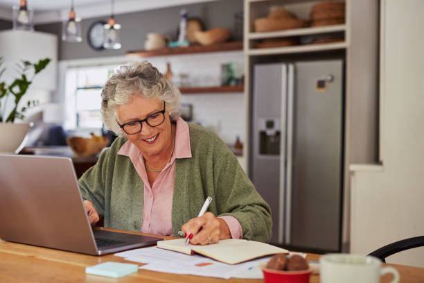 istock Happy senior woman working at laptop 2194052838