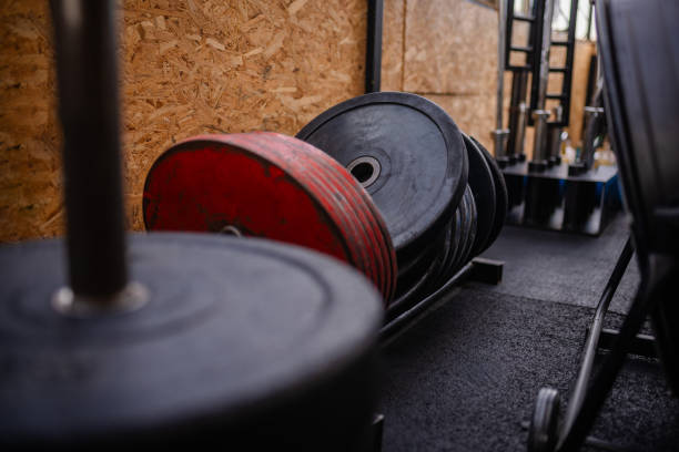 istock Gym weight plates stacked neatly with workout tools 2194053118