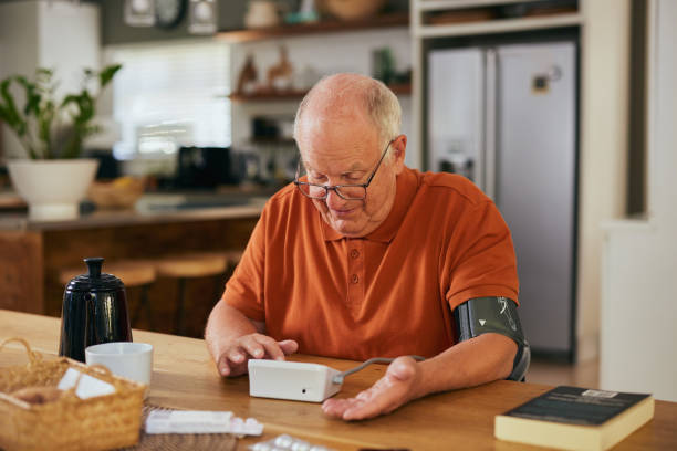 istock Happy old man measuring blood pressure at home 2194053908