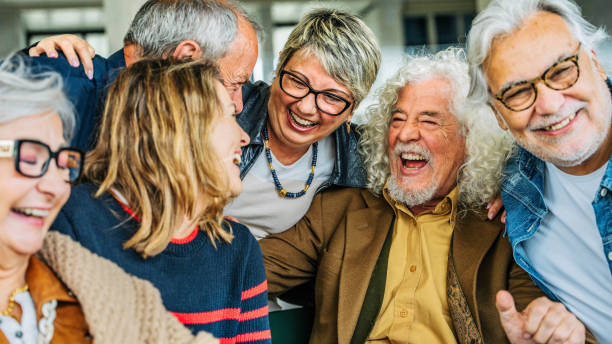 istock Happy group of senior people laughing together 2194054751