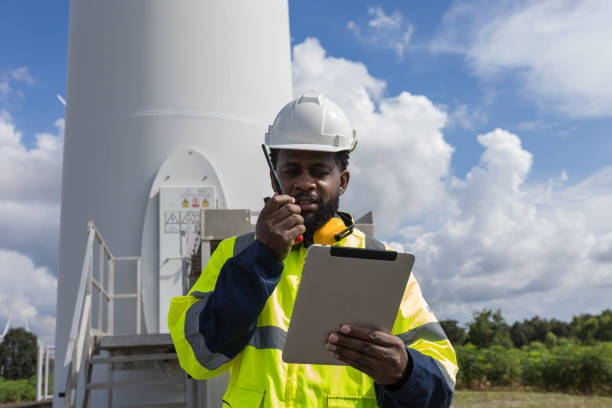 istock Survey Team Alternative energy for future. Engineers survey and checking wind turbines in sunset. Wind Turbine Renewable energy technology and sustainability. 2194055134
