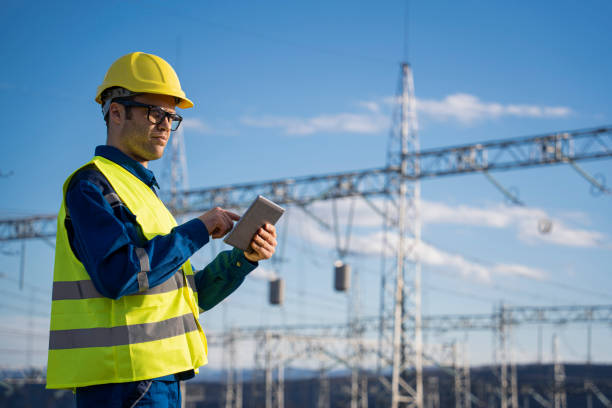 istock Engineer with tablet at an electrical power station checking equipment for maintenance. 2194055259