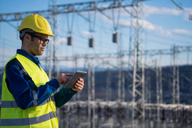 istock Engineer with tablet at an electrical power station checking equipment for maintenance. 2194055271