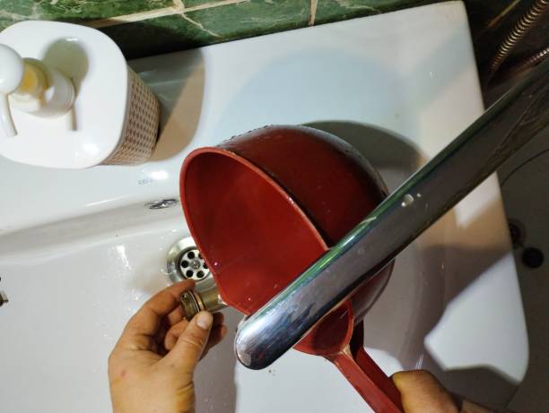 istock Washing a water filter under a stream of water over a sink. A person washes a mesh filter. 2194055384