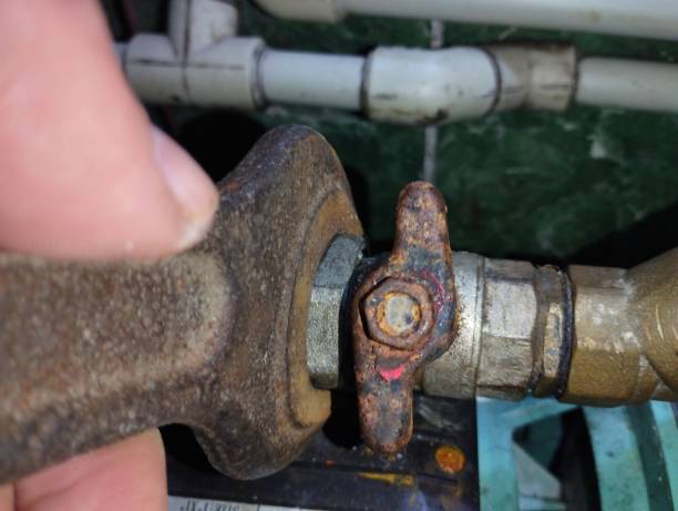 istock Repair and replacement of water supply system elements. Unscrewing a water tap with an open-end wrench to replace it. 2194055407