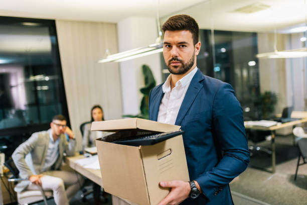 istock Businessman got fired from his job. Taking box with his personal stuff from the office. 2194055942
