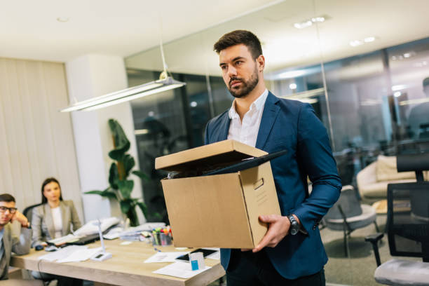 istock Businessman got fired from his job. Taking box with his personal stuff from the office. 2194056055