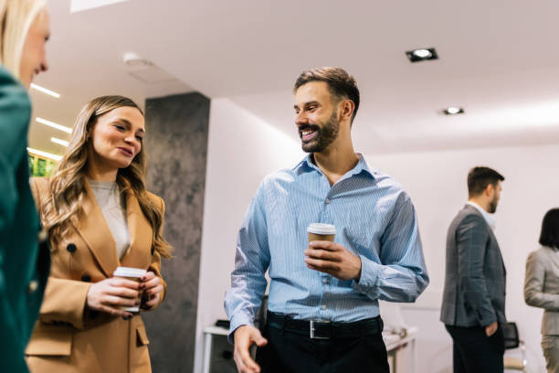 istock Business people on a coffee break during a seminar. Standing in the office and talking about the job. 2194056154