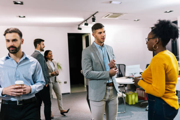 istock Business people on a coffee break during a seminar. Standing in the office and talking about the job. 2194056155