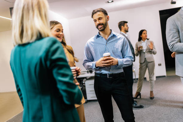 istock Business people on a coffee break during a seminar. Standing in the office and talking about the job. 2194056157