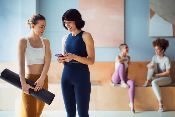 istock Friends Enjoying Time Together in a Yoga Studio with Warm Atmosphere 2194056282