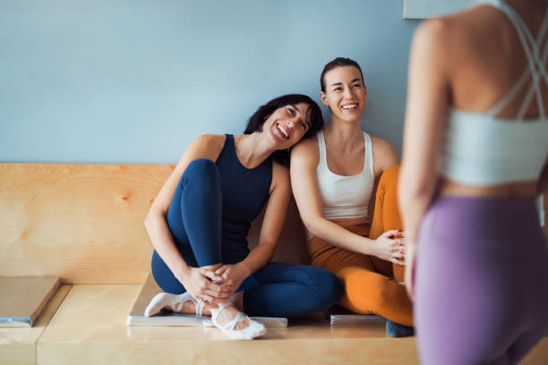Relaxed Friends in Activewear Sharing Time at a Yoga Studio