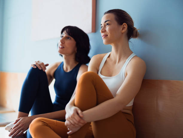 istock Two Friends Relaxing Together After Exercise in a Calm, Modern Space 2194056300