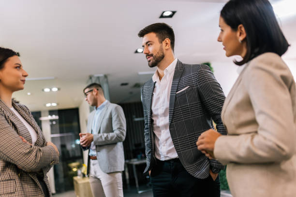 istock Business people on a coffee break during a seminar. Standing in the office and talking about the job. 2194056312