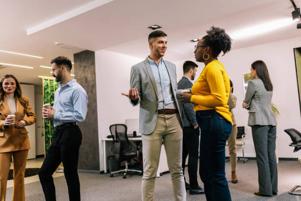 istock Business people on a coffee break during a seminar. Standing in the office and talking about the job. 2194056314