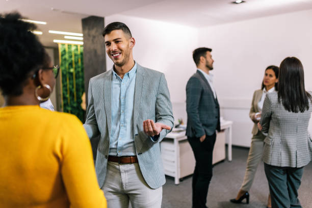 istock Business people on a coffee break during a seminar. Standing in the office and talking about the job. 2194056321