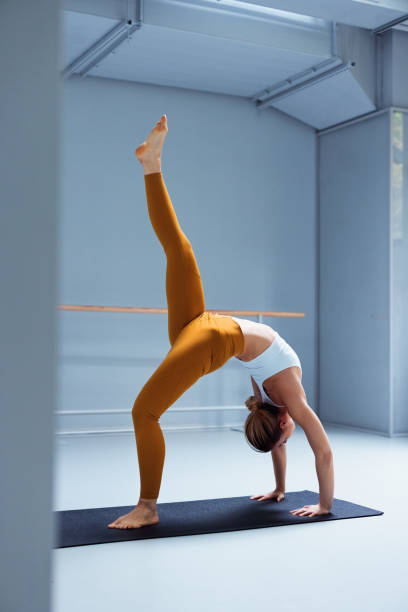 Fitness Enthusiast Practicing Yoga in a Modern Indoor Studio Environment