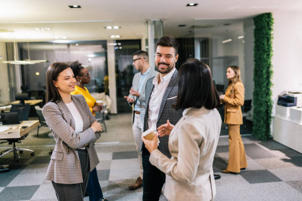 istock Business people on a coffee break during a seminar. Standing in the office and talking about the job. 2194056684