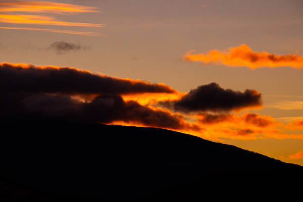 Beautiful sunset sky. The setting sun in a cloudy sky background