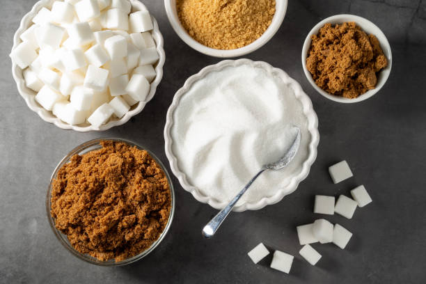 istock Different type of sugar. Light brown, dark brown and white sugar cubes in bowls. 2194058490