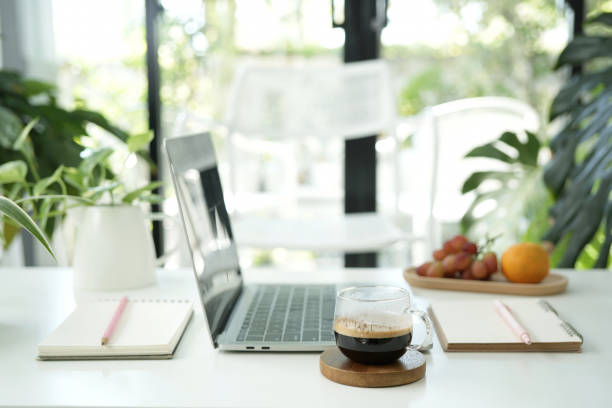 istock laptop and coffee cup with notebook and plants pot and orange on white table work from home office 2194058788