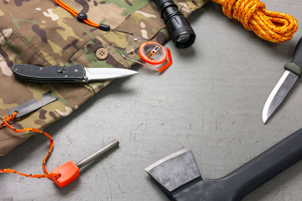 istock Bushcraft and survival equipment on a grey wooden background 2194059451