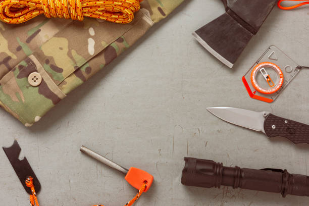 istock Bushcraft and survival equipment on a grey wooden background 2194059475