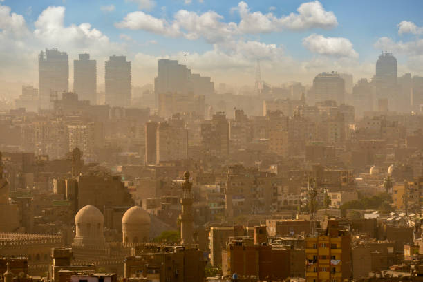 Cairo cityscape with mosques and buildings emerging from polluted air