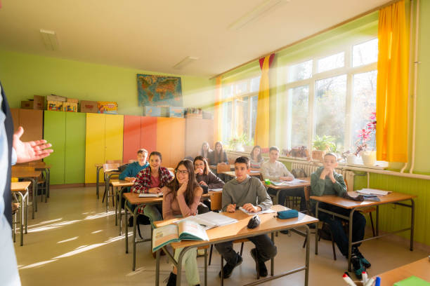 istock Schoolchildren listening teacher during the class 2194060515